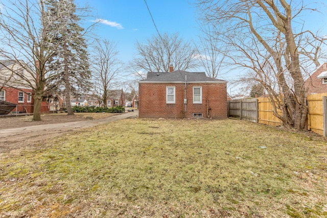 rear view of property with a lawn