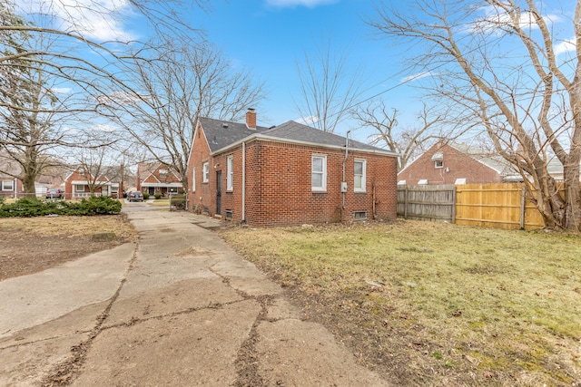 view of side of home with a lawn