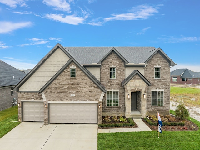 view of front of home featuring a garage and a front yard