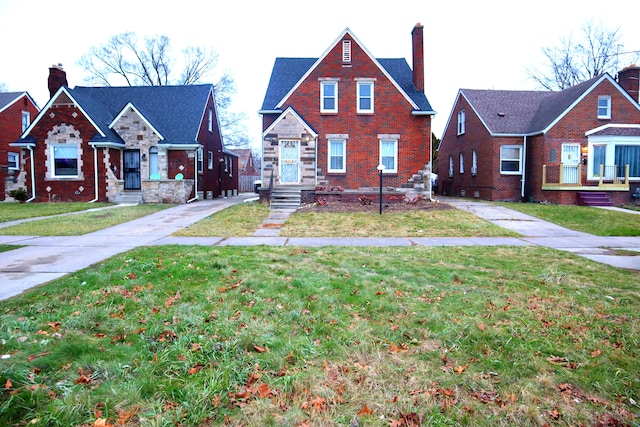 bungalow-style home featuring a residential view, a front lawn, concrete driveway, and brick siding