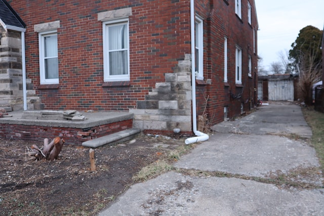 view of side of home with brick siding