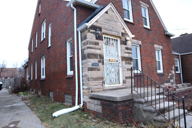 view of side of property with stone siding and brick siding