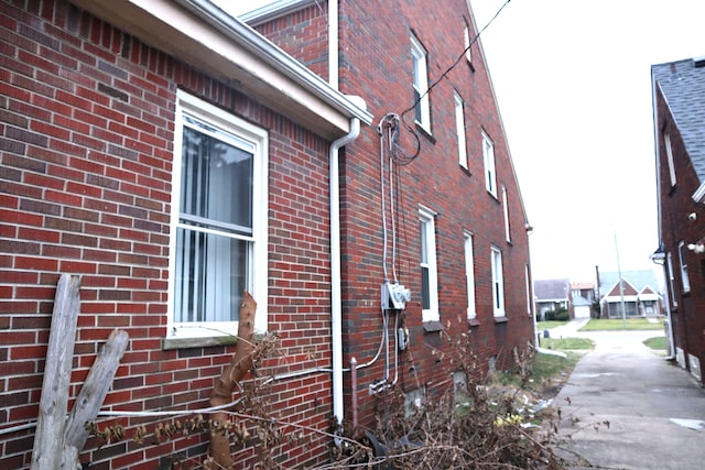 view of side of home with brick siding