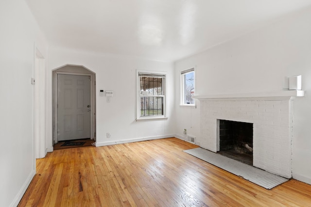 unfurnished living room with a fireplace and light hardwood / wood-style flooring