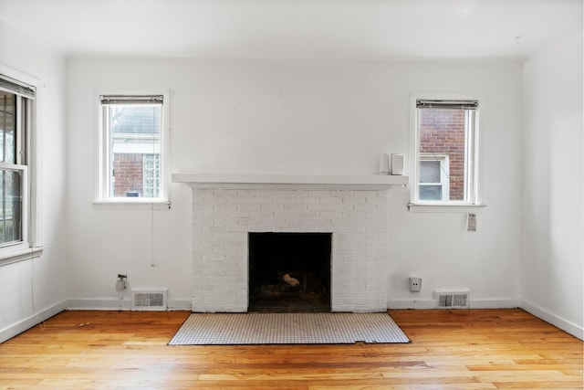 room details with hardwood / wood-style floors and a brick fireplace