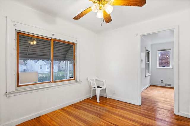 spare room with ceiling fan and light wood-type flooring