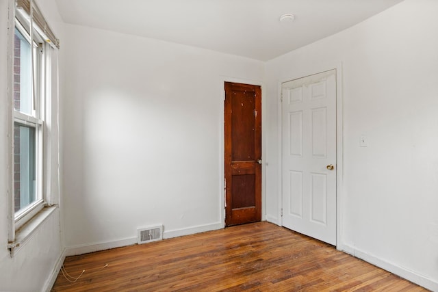 empty room with wood-type flooring