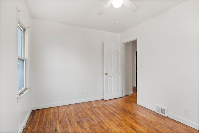 unfurnished room with light wood-type flooring, ceiling fan, and a healthy amount of sunlight