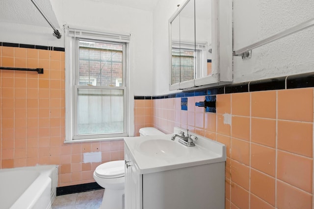 full bathroom featuring tile patterned floors, plenty of natural light, vanity, and tile walls