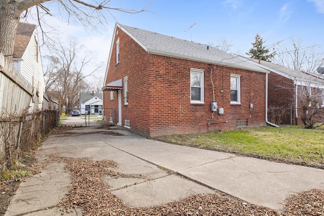 view of side of property with a lawn