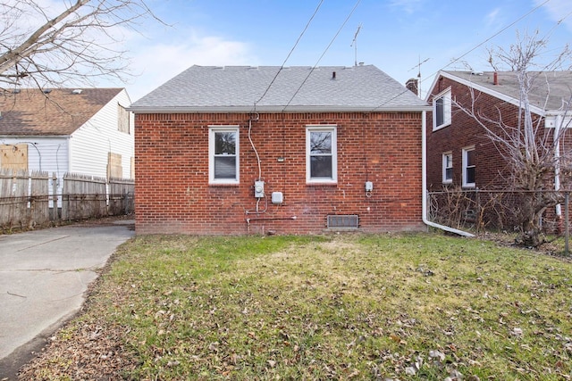 back of property featuring a lawn