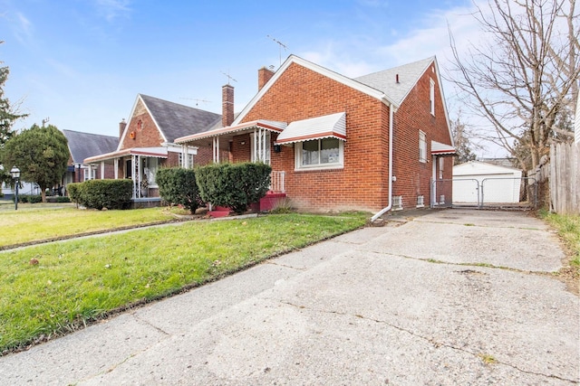 view of front of property with a front yard, an outdoor structure, and a garage