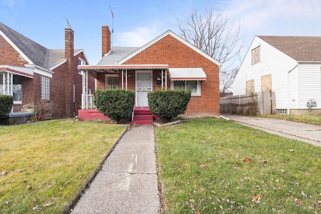 bungalow-style home featuring a front lawn and a porch