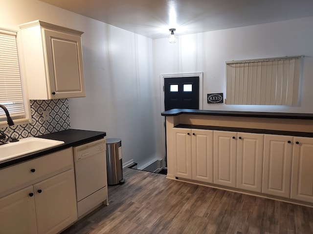 kitchen with white cabinets, white dishwasher, dark wood-type flooring, and sink