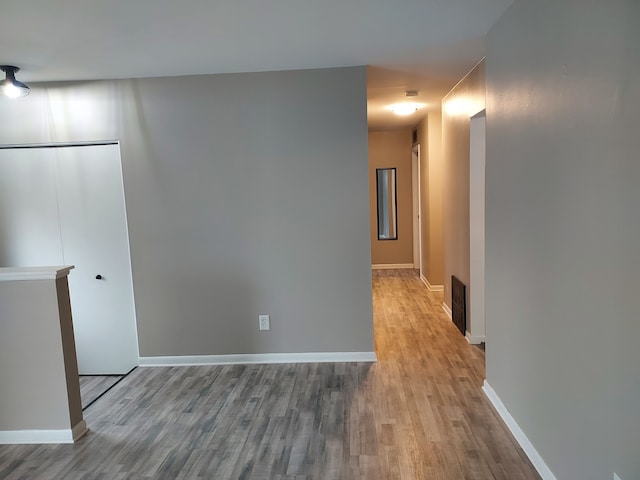 hallway with light hardwood / wood-style flooring