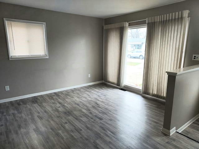 spare room with dark hardwood / wood-style flooring