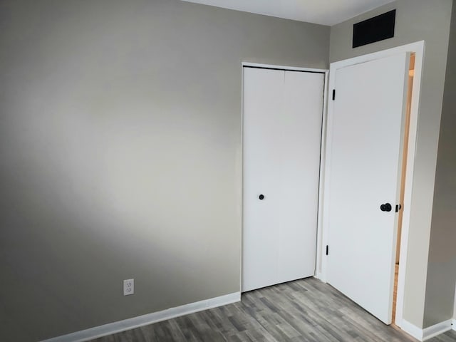 unfurnished bedroom featuring a closet and light hardwood / wood-style flooring