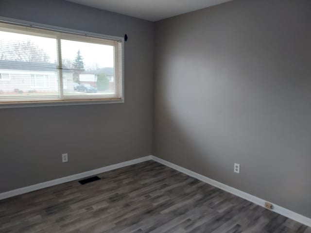 empty room featuring dark hardwood / wood-style floors