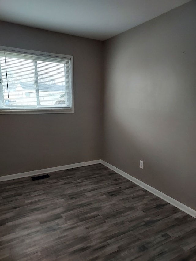 unfurnished room featuring dark hardwood / wood-style flooring