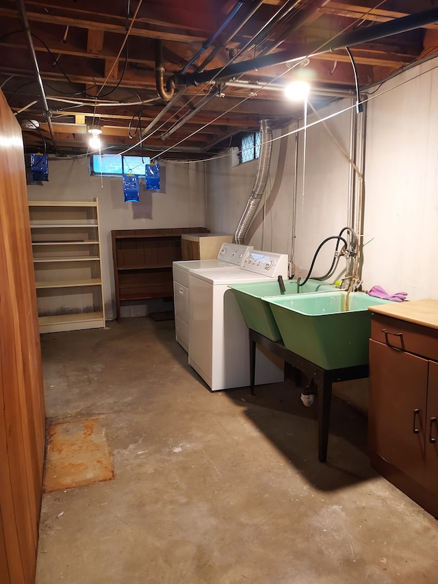 basement featuring washing machine and clothes dryer and sink