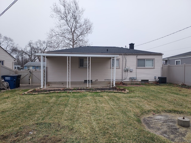 rear view of house with a patio area, a yard, and central AC