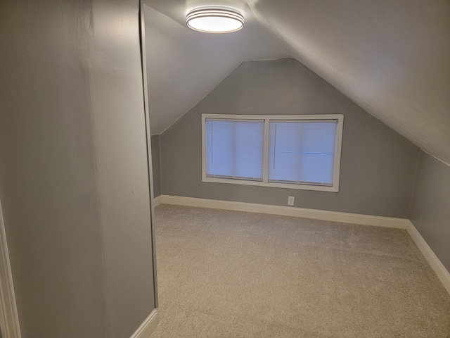 bonus room with carpet flooring, baseboards, and vaulted ceiling