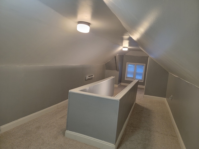 bonus room with vaulted ceiling, carpet, and baseboards