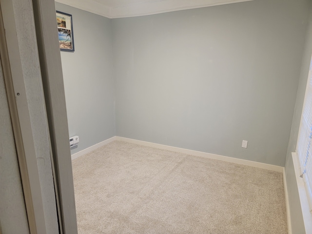 spare room with baseboards and carpet