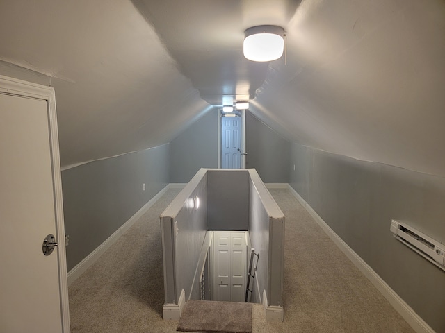 stairway featuring a baseboard heating unit, vaulted ceiling, carpet flooring, and baseboards