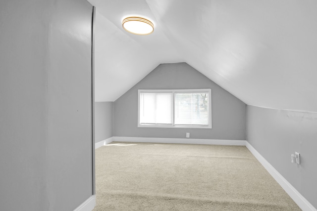 bonus room with carpet flooring, baseboards, and lofted ceiling