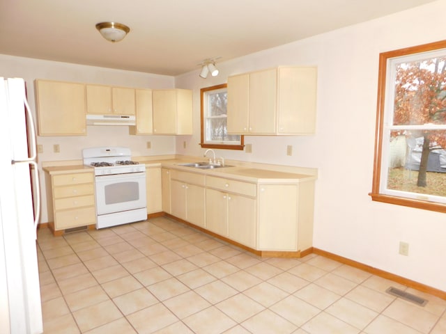 kitchen featuring light tile patterned floors, white appliances, and sink