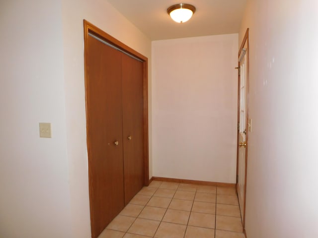 corridor featuring light tile patterned floors