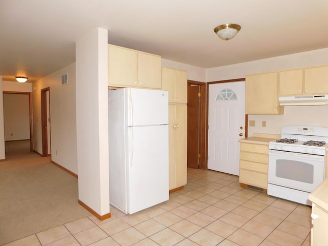 kitchen featuring light tile patterned floors, white appliances, and cream cabinetry