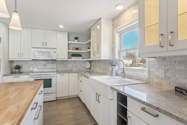 kitchen featuring butcher block counters, decorative light fixtures, white appliances, decorative backsplash, and white cabinets