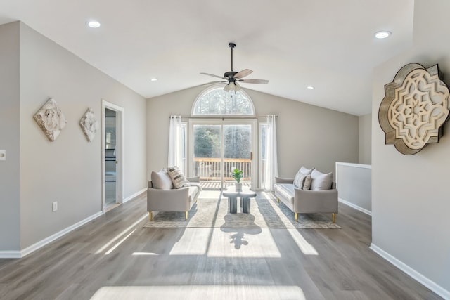 living room featuring wood-type flooring, ceiling fan, and lofted ceiling