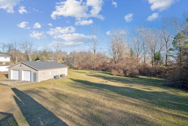 view of yard featuring cooling unit and a garage