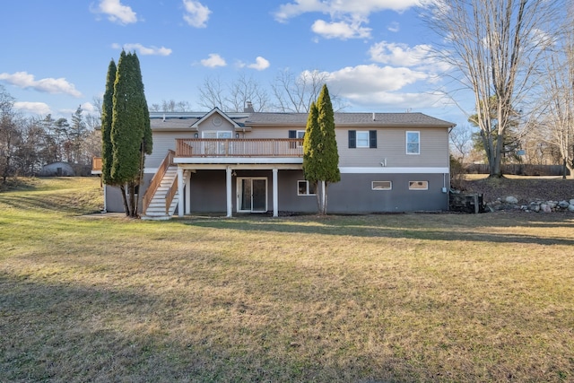 back of property with a wooden deck and a yard