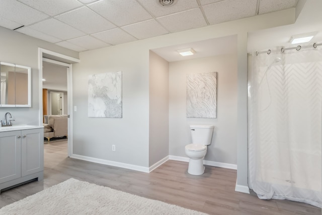 bathroom featuring hardwood / wood-style floors, vanity, toilet, and walk in shower