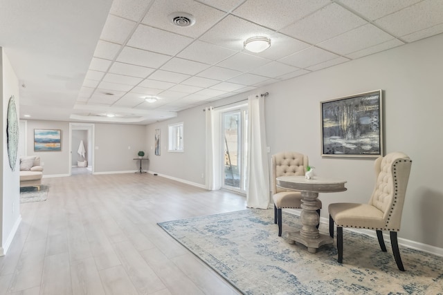 sitting room featuring a paneled ceiling and light hardwood / wood-style flooring