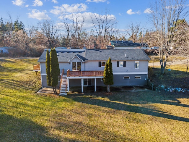 back of property featuring a wooden deck and a yard