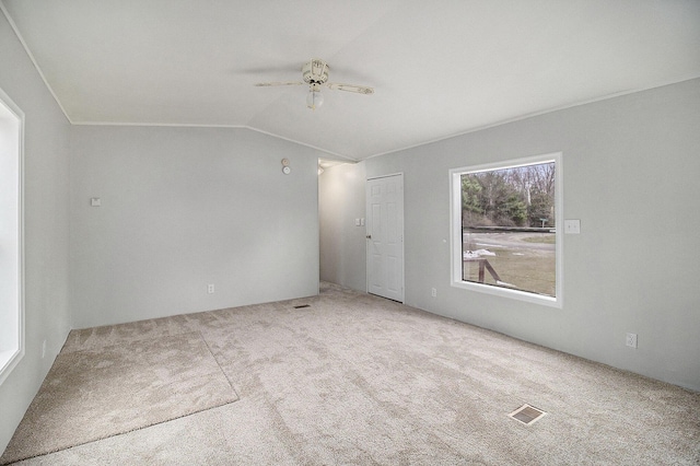 unfurnished room featuring light colored carpet, ceiling fan, and lofted ceiling