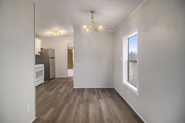 unfurnished dining area featuring a chandelier, a wealth of natural light, dark wood-type flooring, and lofted ceiling