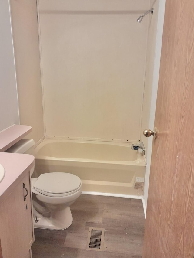 bathroom with vanity, toilet, and wood-type flooring