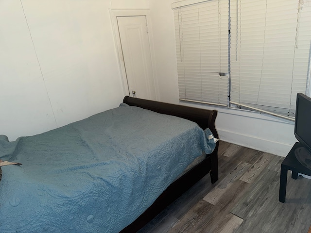 bedroom featuring dark hardwood / wood-style flooring