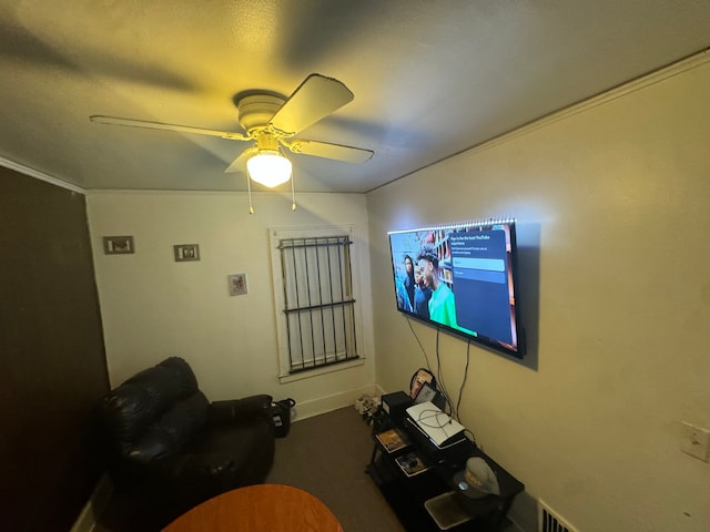 unfurnished living room with carpet floors, ceiling fan, and ornamental molding