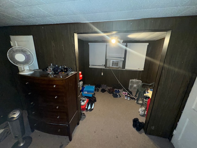 carpeted bedroom with wood walls