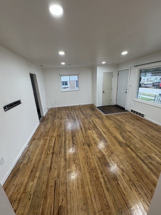 unfurnished living room featuring dark wood-type flooring