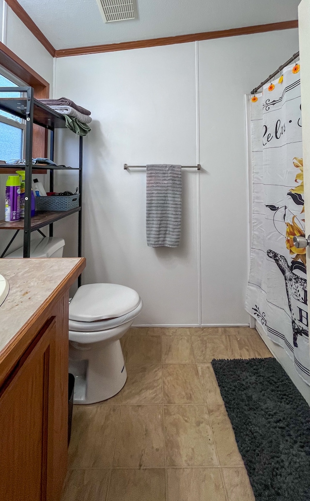 bathroom with vanity, toilet, ornamental molding, a textured ceiling, and walk in shower