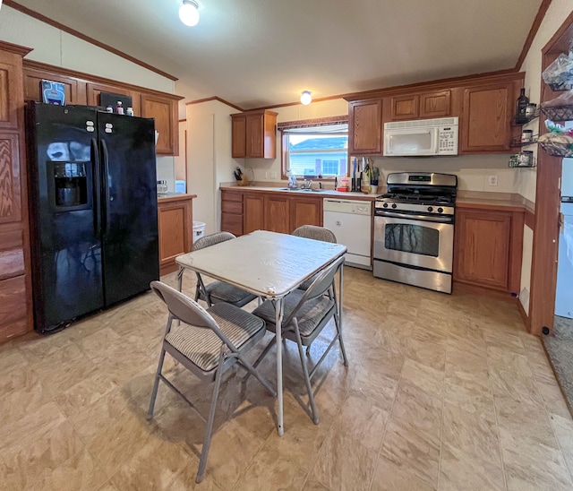 kitchen featuring lofted ceiling, sink, white appliances, and crown molding