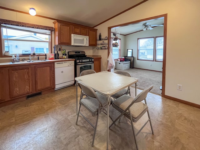 kitchen with white appliances, ceiling fan, lofted ceiling, and sink